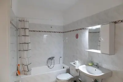 a bathroom with a sink and a toilet and a bath tub at Airport city center 2 in Spáta