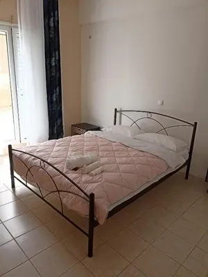 a bedroom with a bed with a metal frame at Airport city center 2 in Spáta