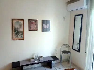 a room with a table and a chair and pictures on the wall at Athens Cityscape in Athens