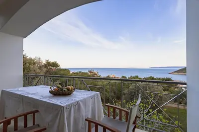 a table with a basket of fruit on a balcony at Eternal Summer Time Villa for 6 by Filos Inc in Dhaskalión