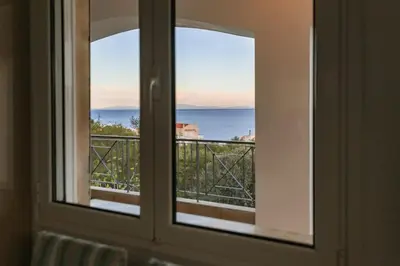 a view of the ocean from a window at Eternal Summer Time Villa for 6 by Filos Inc in Dhaskalión