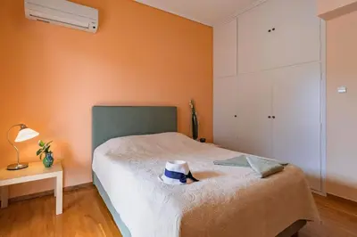 a bedroom with a bed with a hat on it at Eternal Summer Time Villa for 6 by Filos Inc in Dhaskalión