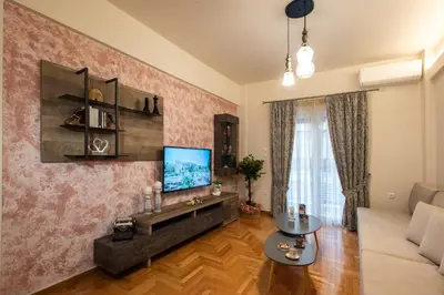 a living room with a couch and a tv at Blue Ark Acropolis Compass in Athens