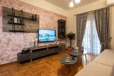 a living room with a flat screen tv on a wall at Blue Ark Acropolis Compass in Athens