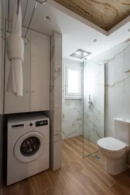a bathroom with a washing machine and a toilet at Blue Ark Acropolis Compass in Athens