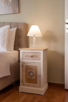 a nightstand with a lamp on it next to a bed at Blue Ark Acropolis Compass in Athens