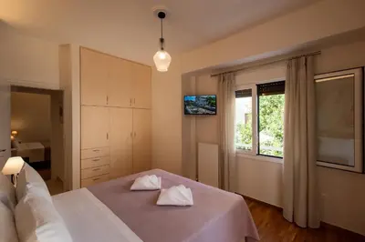 a bedroom with a bed with two white towels on it at Blue Ark Acropolis Compass in Athens
