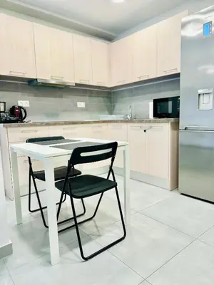 a kitchen with a white table and a black chair at Harmony apartment next to the Acropolis museum in Athens