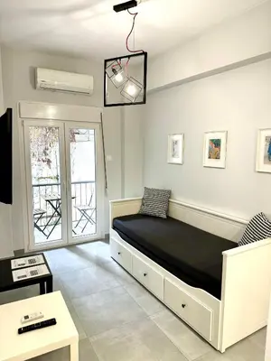a bedroom with a bed in a room with a window at Harmony apartment next to the Acropolis museum in Athens