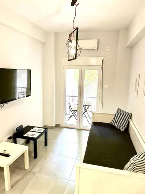 a living room with a couch and a table at Harmony apartment next to the Acropolis museum in Athens
