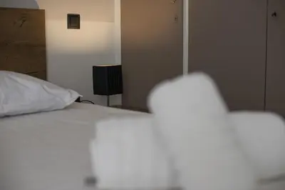 a bedroom with a white bed and a lamp at Blue Dream Modern Piraeus Apt, Walk to Beach in Piraeus