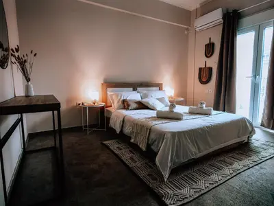 a bedroom with a large bed and a window at Bohemian Apartment in Central Athens in Athens