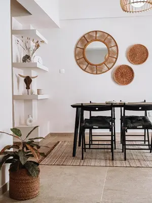 a dining room with a table and chairs and mirrors at Bohemian Apartment in Central Athens in Athens