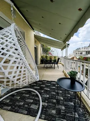 a hammock on a balcony with a table and chairs at Bohemian Apartment in Central Athens in Athens