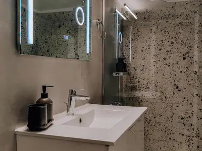 a bathroom with a white sink and a mirror at Bohemian Apartment in Central Athens in Athens