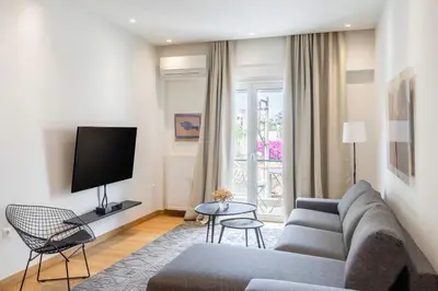 a living room with a couch and a tv at The Urban Nest Design 1BR in Trendy Kerameikos in Athens
