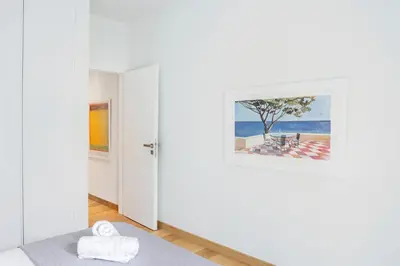 a room with white walls and a painting on the wall at The Urban Nest Design 1BR in Trendy Kerameikos in Athens