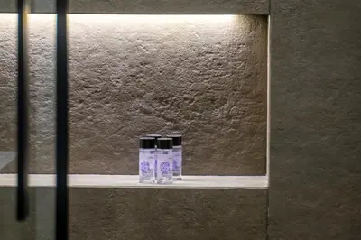 two bottles sitting on a shelf in front of a window at The Urban Nest Design 1BR in Trendy Kerameikos in Athens