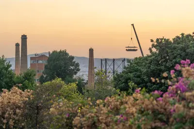 a crane in a city with trees and flowers at The Urban Nest Design 1BR in Trendy Kerameikos in Athens