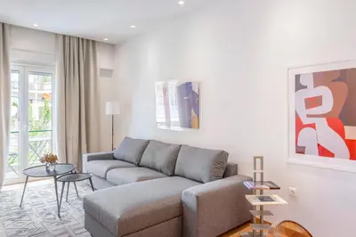 a living room with a couch and a table at The Urban Nest Design 1BR in Trendy Kerameikos in Athens