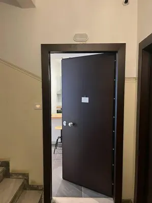 a black door in a room with stairs at Cozy & modern apartment near Panathenaic Stadium in Athens