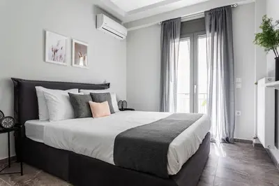 a bedroom with a large bed and a large window at Sublime 1BR Apartment in Koukaki by UPSTREET in Athens
