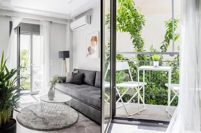 a living room with a couch and a table at Sublime 1BR Apartment in Koukaki by UPSTREET in Athens