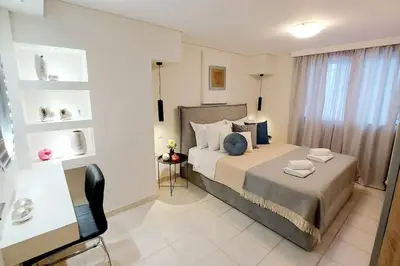a bedroom with a bed and a chair in a room at Inspiration Alimos Getaway, close to the beach in Athens