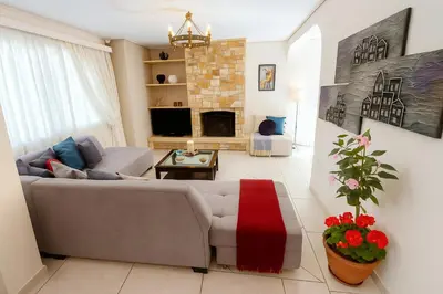 a living room with a couch and a fireplace at Inspiration Alimos Getaway, close to the beach in Athens