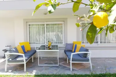 a patio with two chairs and a glass table at Inspiration Alimos Getaway, close to the beach in Athens