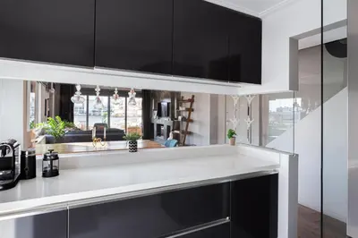 a kitchen with black cabinets and a white counter top at Glyfada Luxury Living in Athens