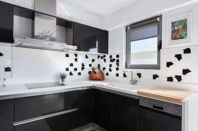 a kitchen with black and white tiles on the wall at Glyfada Luxury Living in Athens