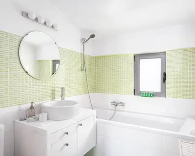 a bathroom with a sink and a tub and a mirror at Glyfada Luxury Living in Athens