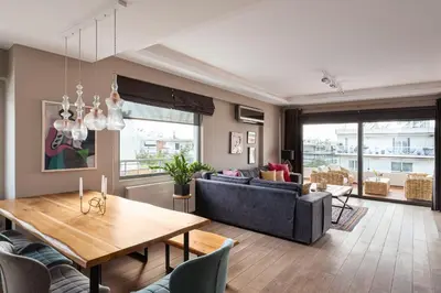 a living room with a table and a couch at Glyfada Luxury Living in Athens