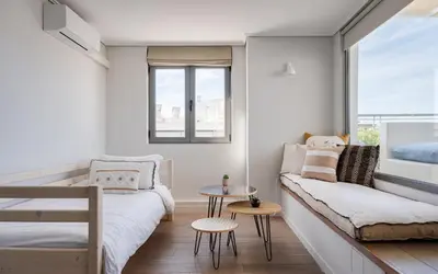 a living room with a couch and a table at Glyfada Luxury Living in Athens