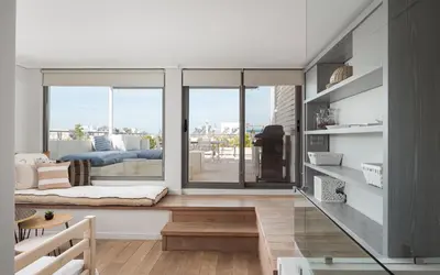 a living room with a view of a balcony at Glyfada Luxury Living in Athens