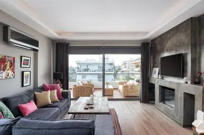 a living room with a couch and a fireplace at Glyfada Luxury Living in Athens