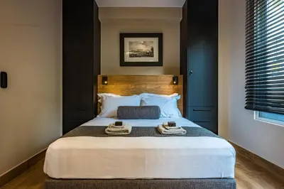 a bedroom with a large bed with two towels on it at Aeanos suite in Athens
