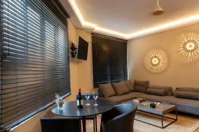 a living room with a couch and a table at Aeanos suite in Athens