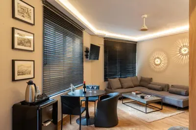 a living room with a couch and a table at Aeanos suite in Athens