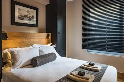 a bedroom with a bed with two towels on it at Aeanos suite in Athens