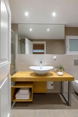 a bathroom with a sink and a mirror at Exclusive Acropolis 4BDR Large Residence in Athens