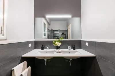a bathroom with two sinks and a mirror at Exclusive Acropolis 4BDR Large Residence in Athens