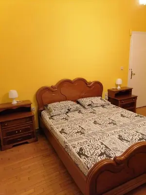 a bed in a bedroom with two nightstands and a bed sidx sidx sidx at Дом для гостей in Athens