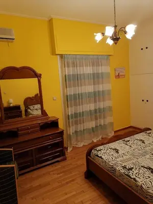 a bedroom with a mirror and a bed and a dresser at Дом для гостей in Athens