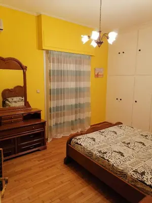 a bedroom with a bed and a dresser and a mirror at Дом для гостей in Athens