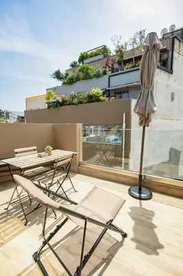 a patio with a table and chairs and an umbrella at City Life Athens Apartments in Athens