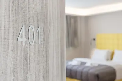 a hotel room with a curtain with a bed in it at City Life Athens Apartments in Athens