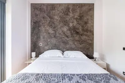 a bedroom with a large bed and a wall at Magnificent, Deluxe Villa, Lagonisi, Athens Riviera in Áyios Nikólaos