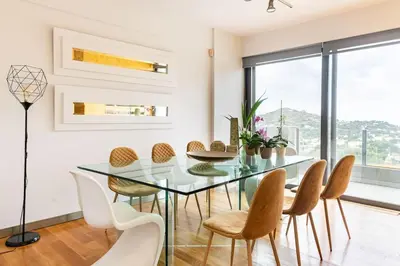 a dining room with a glass table and chairs at Magnificent, Deluxe Villa, Lagonisi, Athens Riviera in Áyios Nikólaos